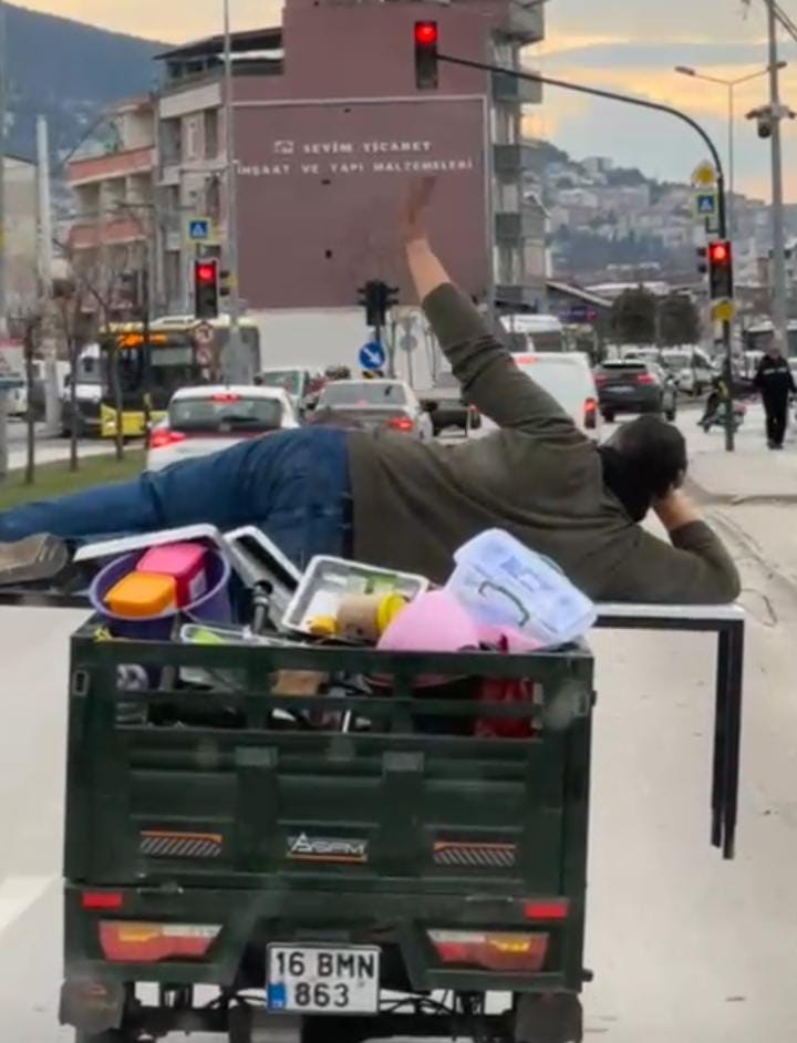Bursa trafiğinde motorun üzerinde yatarak ilerleyen şahıs trafikteki rahat tavırlarıyla dikkat